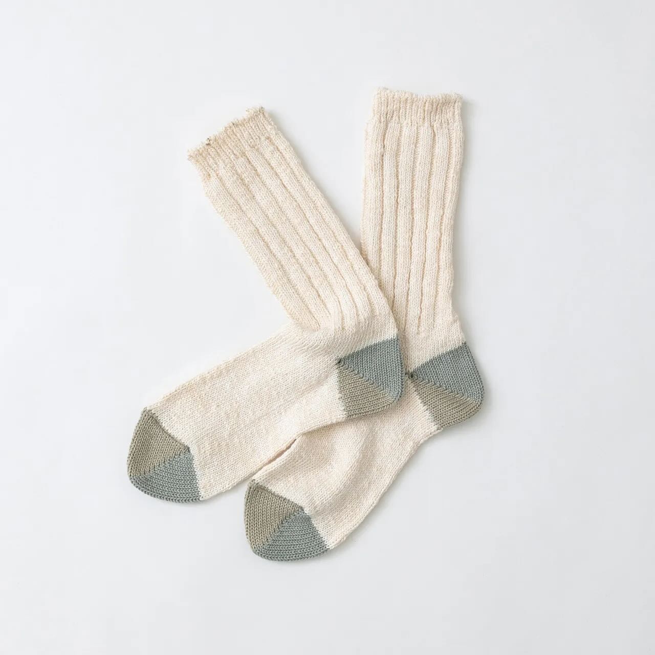Pair of knitted cream socks with gray toes and cuffs